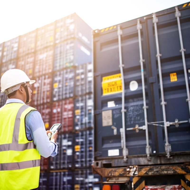 Foreman control loading Containers box from Cargo freight ship f Foreman control loading Containers box from Cargo freight ship for import export, foreman control Industrial Container Cargo freight ship. Logistic concept.